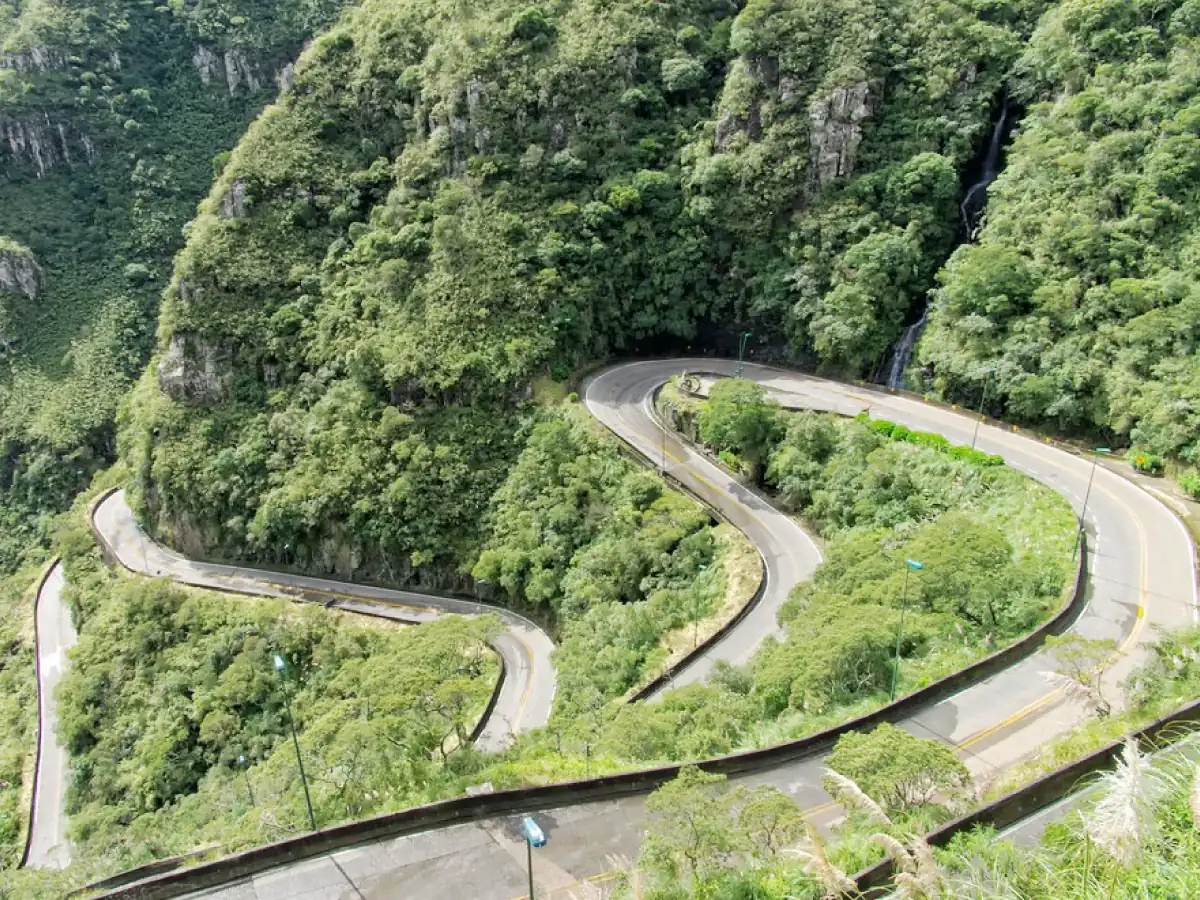 As curvas acentuadas e asfaltadas da Serra do Rio do Rastro, em Santa Catarina, com seus paredões verdes e sem movimento de veículos.